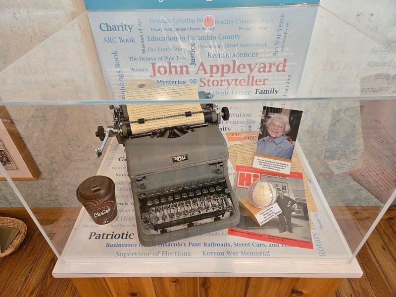Vintage typewriter and historical artifacts on display in Pensacola museum