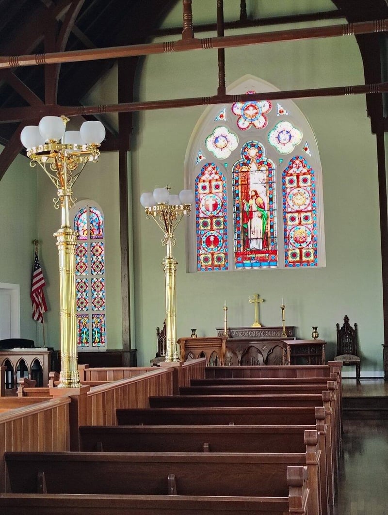 Interior of historic church with stained glass windows in Pensacola Village