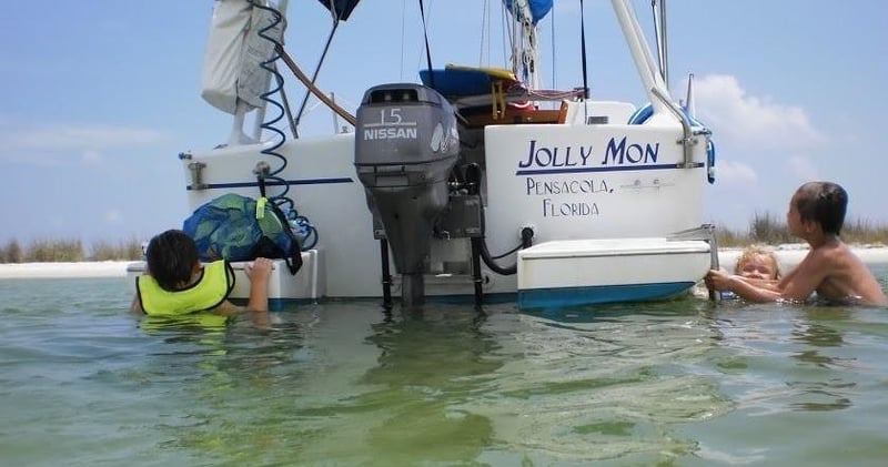 Guests snorkeling near Jolly Mon boat in shallow water Pensacola Beach