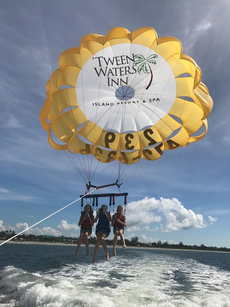 Spot dolphins and beautiful island scenery from the sky during your parasailing flight.