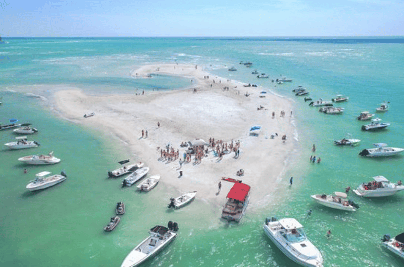 Pontoon boat anchored at the sandbar during the adventure tour