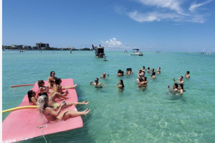 Friends swimming and floating on the lily pad in shallow Gulf waters