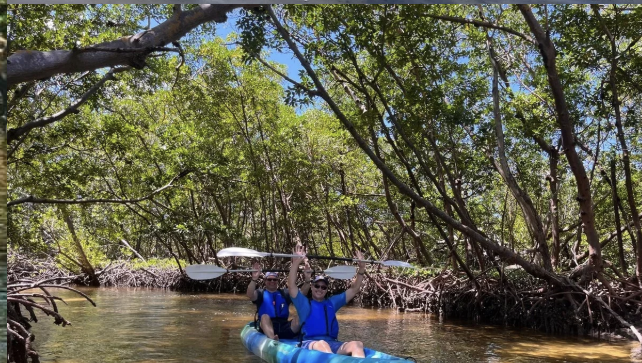 Closeup of kayakers spotting wildlife along the waterway