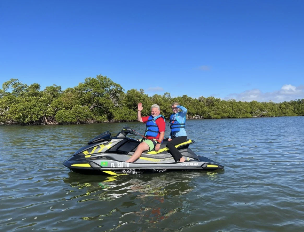 Jet skis moving through open estuary with wide views of the shoreline