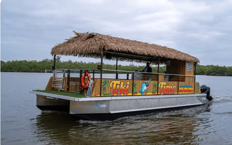 1366951 Private Tiki Boat Cruising Through Calm Naples Coastal Waterways