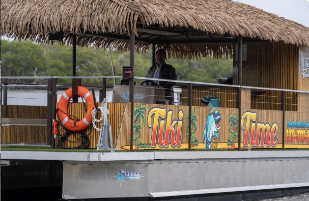 Relaxing cruise on a shaded tiki boat with comfortable seating
