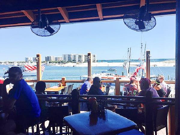 Enjoy Gulf breezes on the porch at AJs, or dine inside.