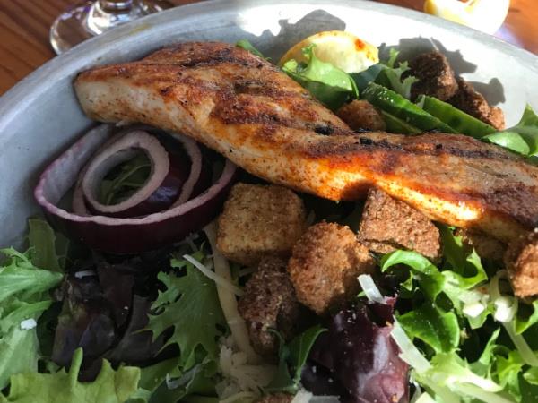 The House Salad topped with the fish of the day at AJs Seafood and Oyster Bar