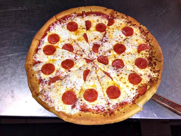 sliced pepperoni pizza at Francos Italian restaurant in Orange Beach, AL