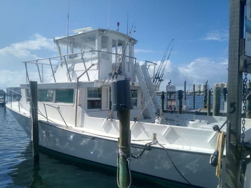 The AlLin fishing charter at wooden dock at Destin Fishing Fleet Marina