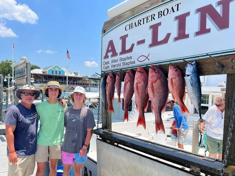 A family showing off their catch on the dock