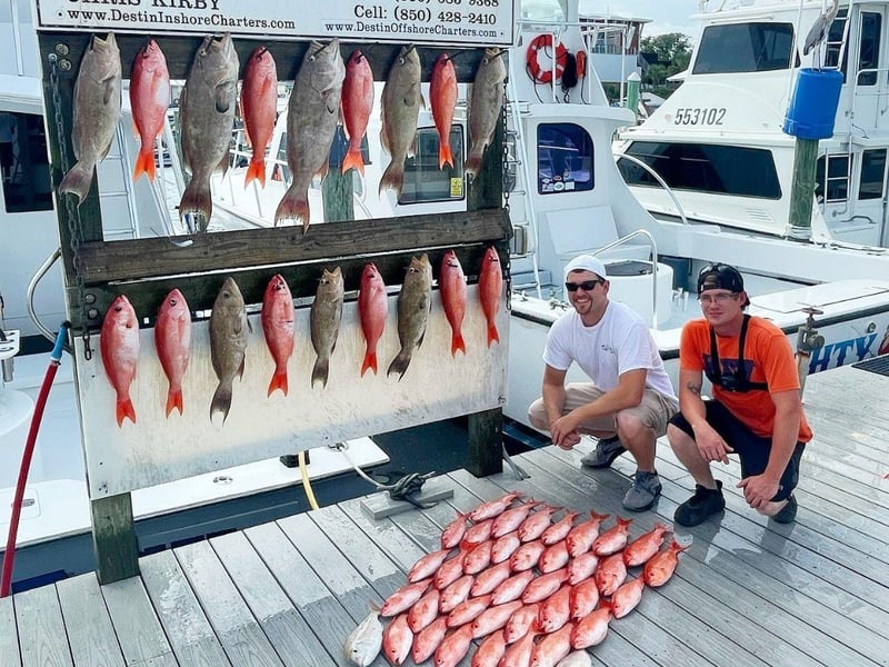 A group showing off their catches on the dock in Destin, Florida