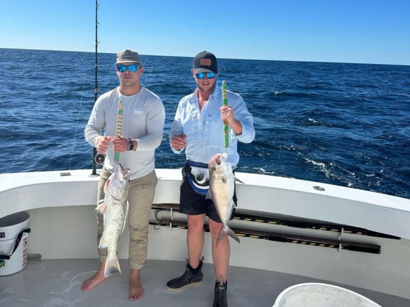 Two men holding to fish on Big John off the coast of Destin, Florida