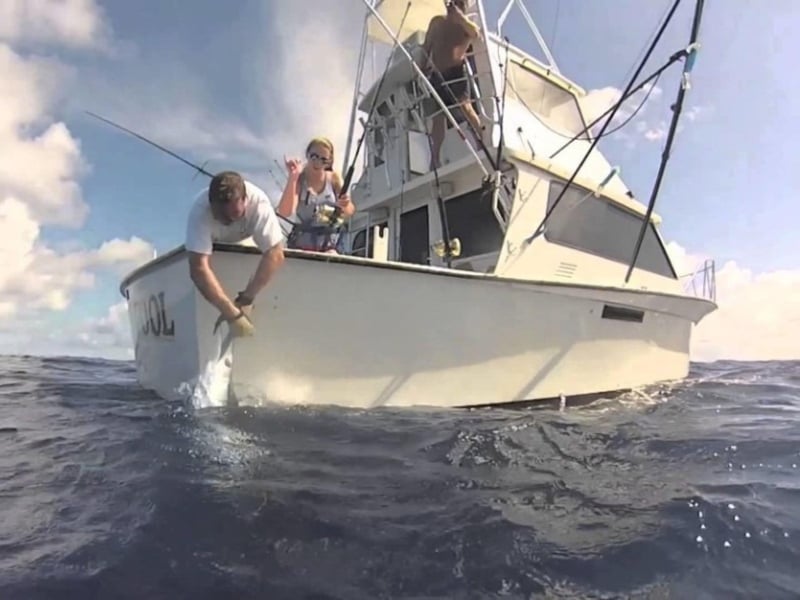 People fishing off the side of FishNFool in Destin, Florida