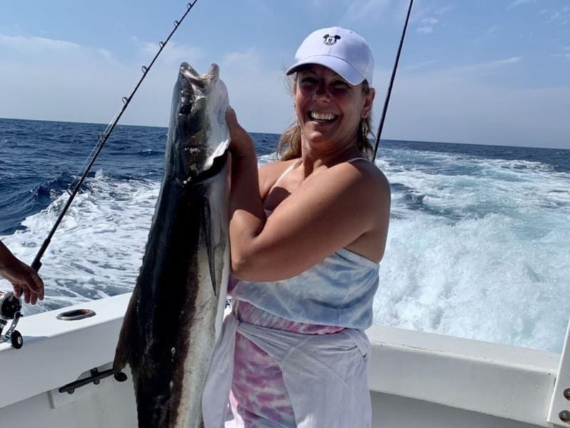 A women holding her catch aboard FishNFool in Destin, Florida