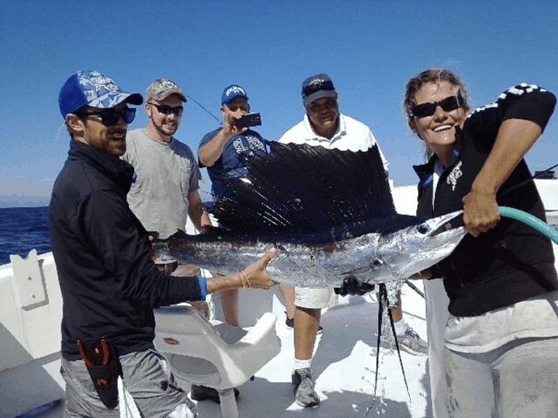 A group holding their catches on board Miss Nautica