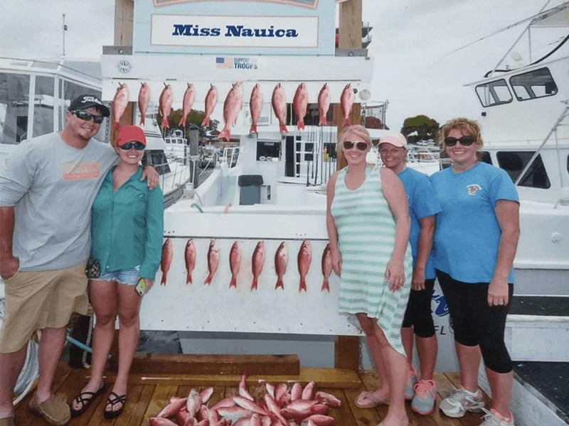 A family with their catches on the dock in Destin, Florida