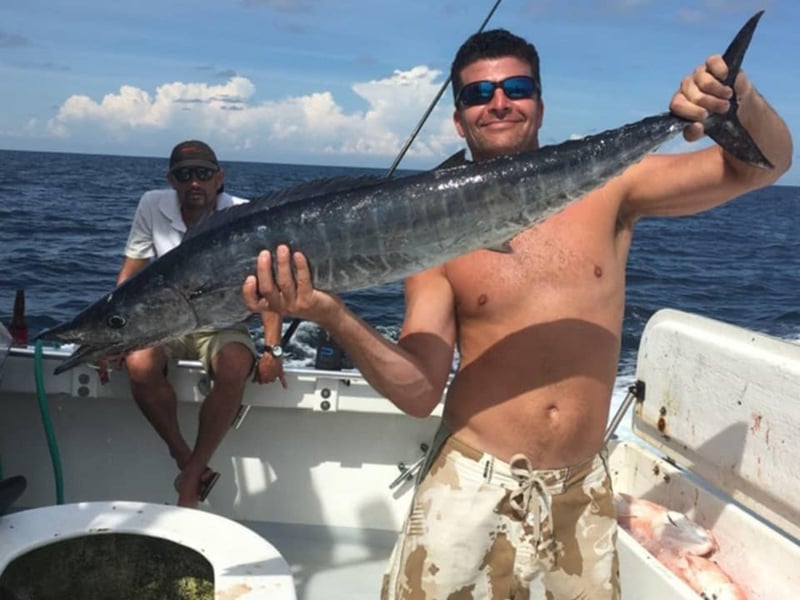 A man showing off his catch on No Alibi