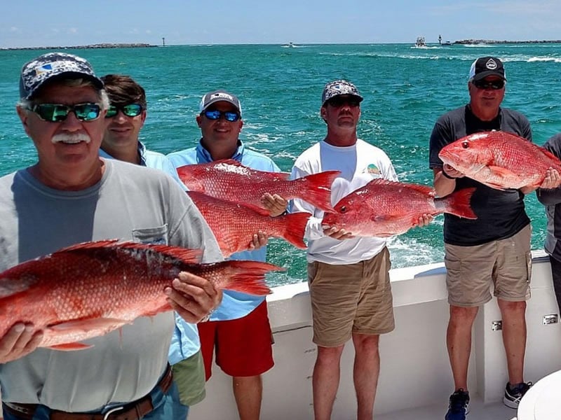 A group with their catches on board Charter Boat Phoenix in Destin, Florida