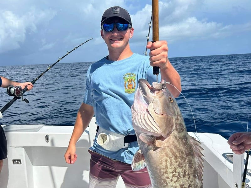 A man showing off his catch on board Charter Boat Phoenix