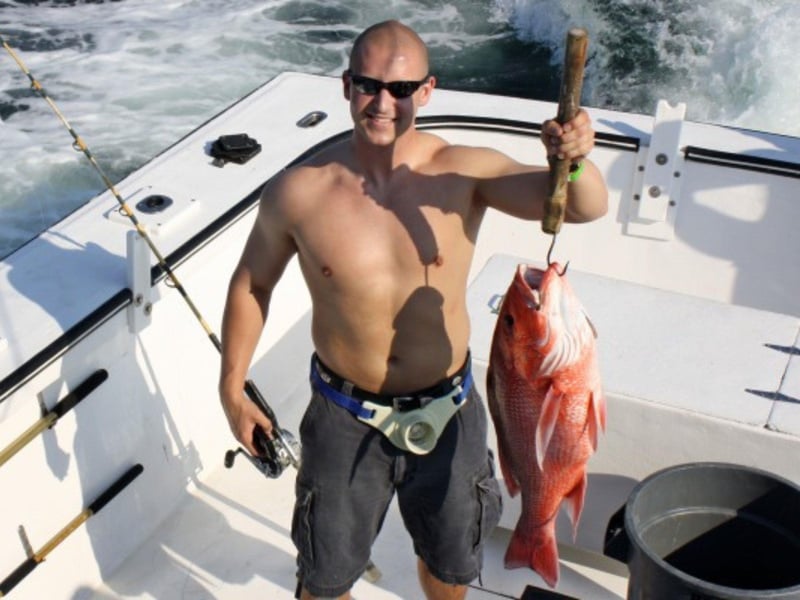 A man with his catch on board Silver Lining in Destin, Florida