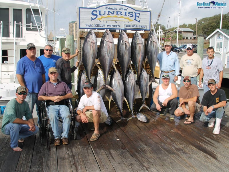 A group showing off their catch on the dock in Destin, Florida
