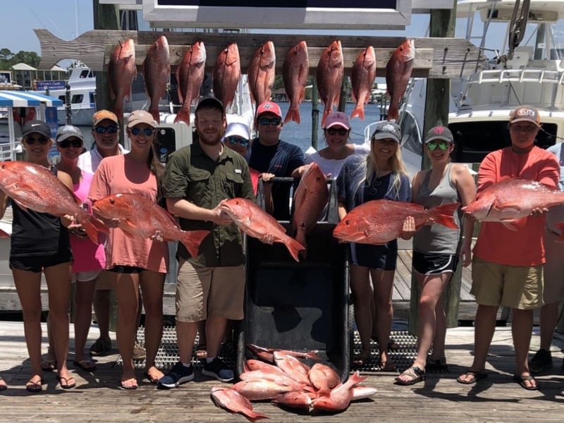 A group on the dock with their catch from Riptide Charters in Orange Beach, Alabama
