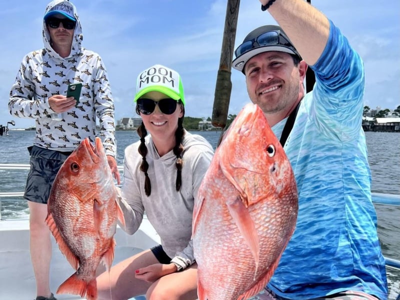 A group showing off their catch on board Rip Tide Charters