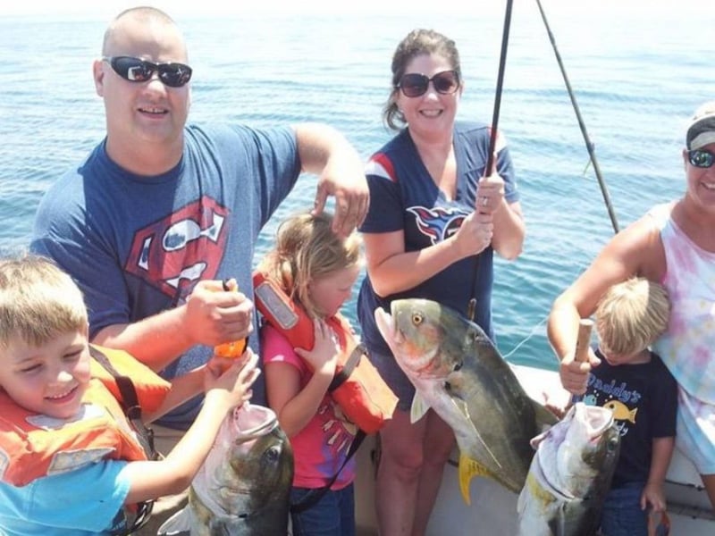 A family showing off their catch on Summer Hunter