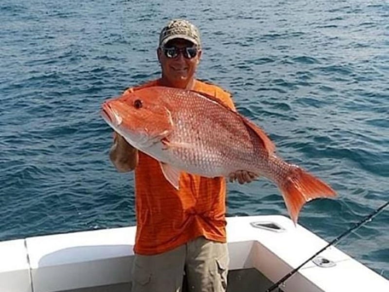 A man with his catch on the water in Orange Beach, Alabama