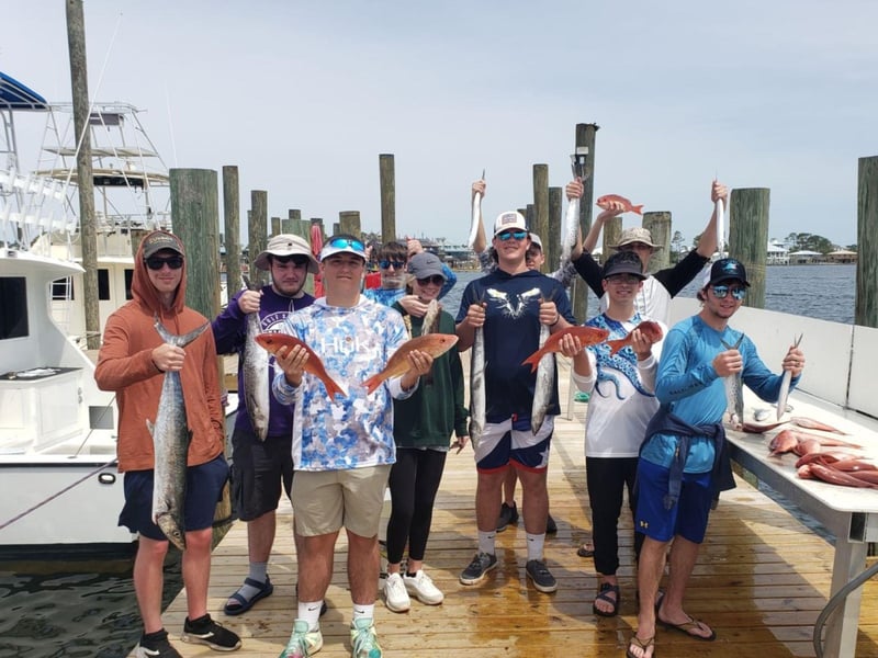 A group showing off their catches on the dock in Orange Beach, Alabama