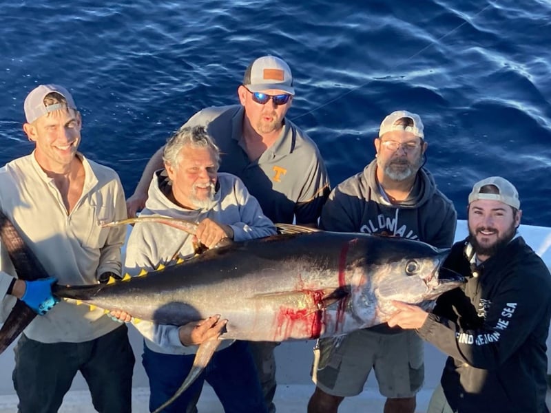 Anglers showing off their catch on board the charter boat