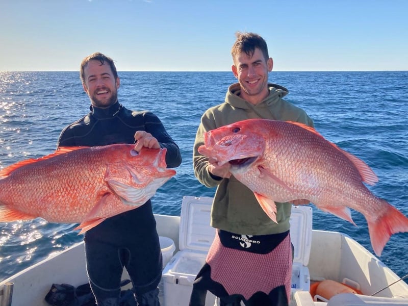 Two men showing off their catches on Gulf Rebel in Orange Beach, Alabama