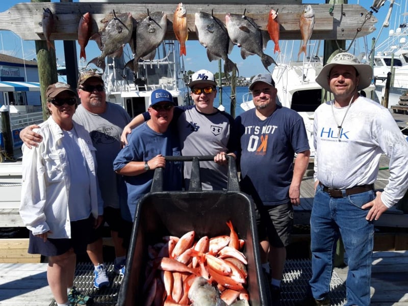 A group with their fish at the dock with Jamie G Charters