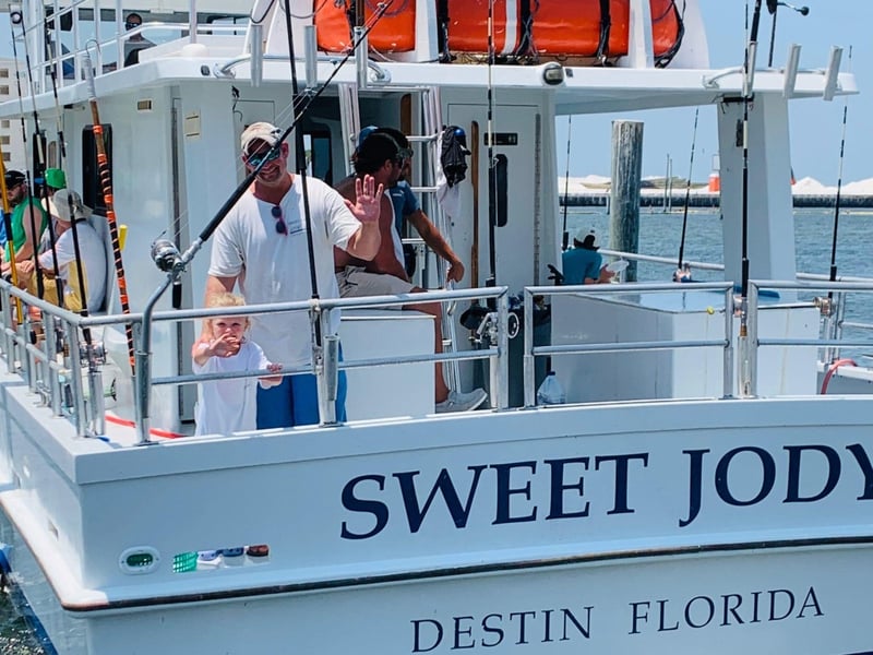 A man fishing off the back of Sweet Jody in Destin, Florida