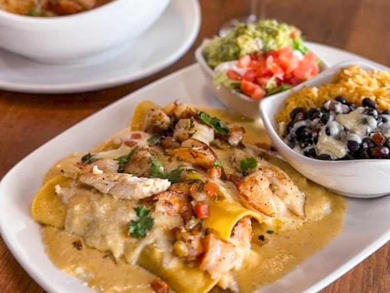 Seafood enchiladas with rice and beans