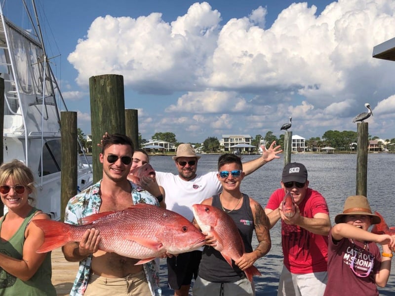 A group showing off their catch on the dock in Orange Beach, Alabama