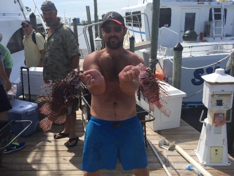 An angler with his fish on the dock in Orange Beach, Alabama
