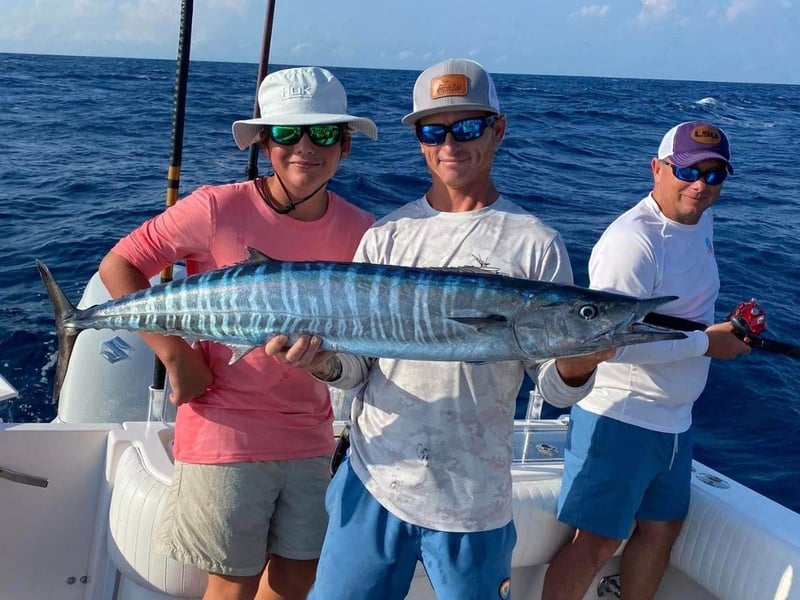 A group with their fish on board JustInTime in Destin, Florida