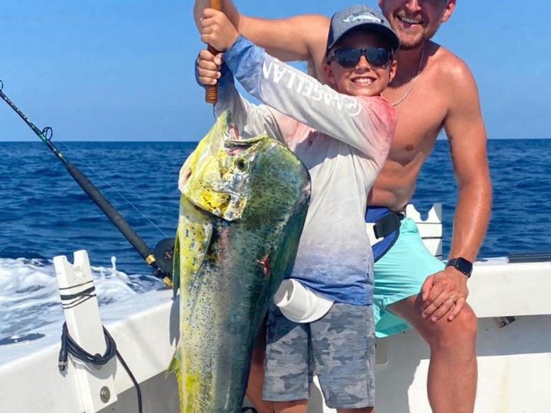 A kid showing off his catch on board Sea Winder in Destin, Florida