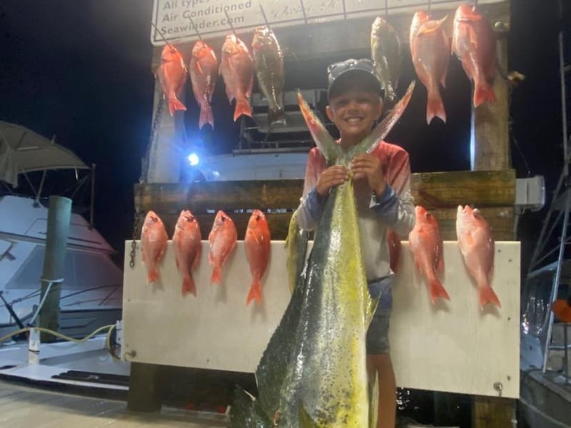 A boy on the dock with his catches from Sea Winder in Destin, Florida