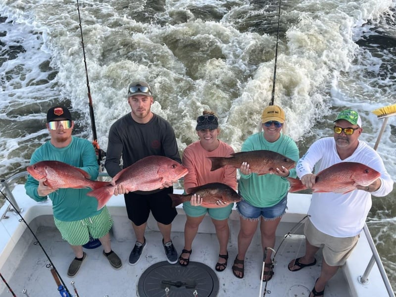 A group with their catches on board Sure Shot in Orange Beach, Alabama