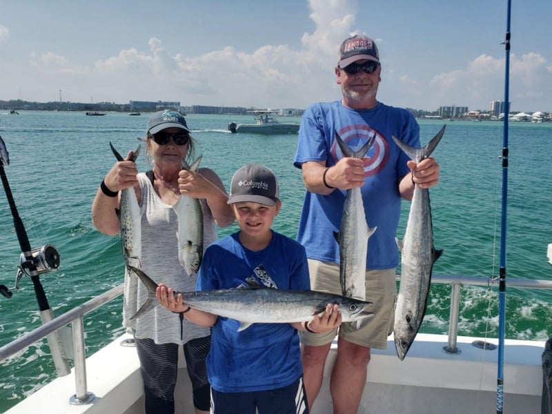 A family with their catches on board Sure Shot in Orange Beach, Alabama