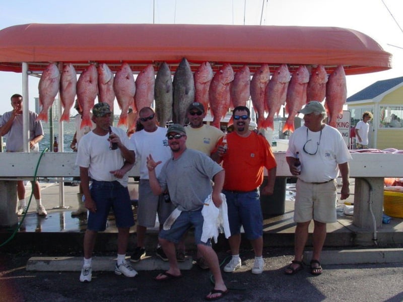 A group with their catch on the dock in Pensacola Beach, Florida