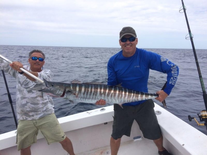 A group with their catch on the dock in Pensacola Beach, Florida