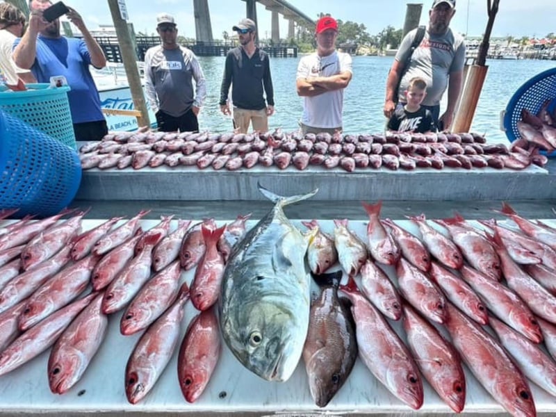 A group with their catch on the dock in Pensacola Beach, Florida