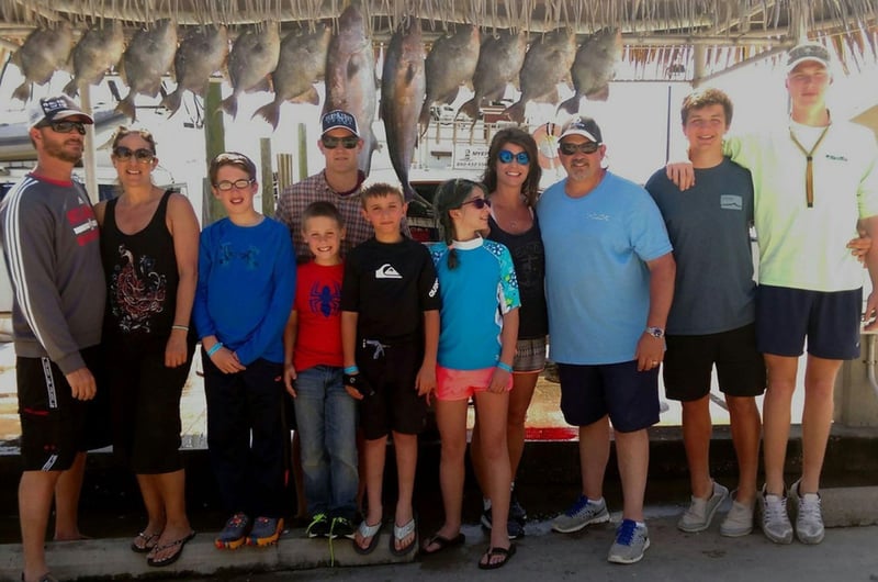 A large group on the dock with their catches from Lively One II