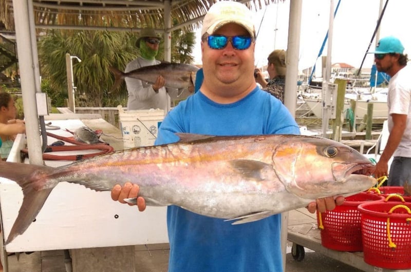 A man with his large Amberjack caught on board Lively One II