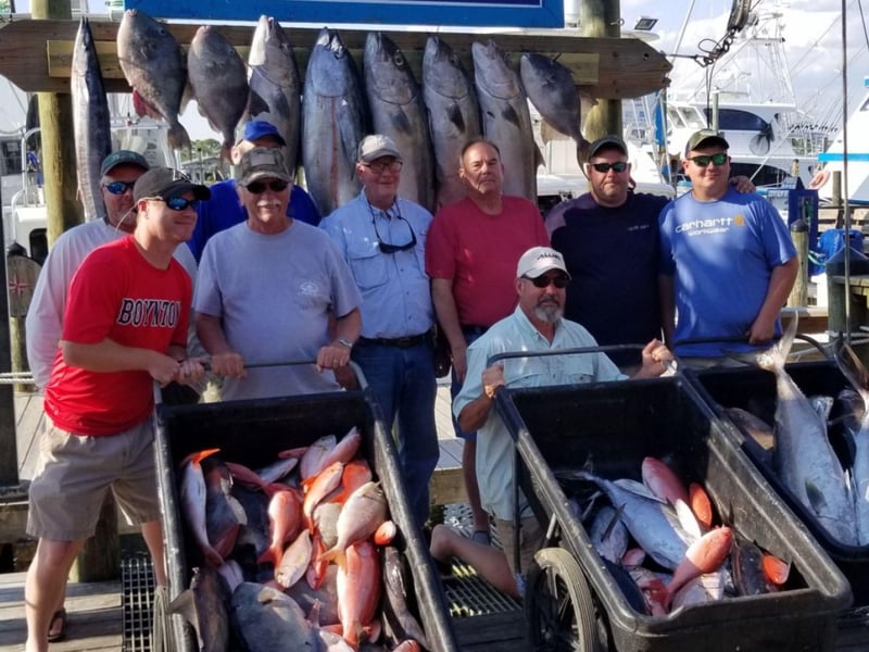 A large group with their catches on the dock in Orange Beach, Alabama