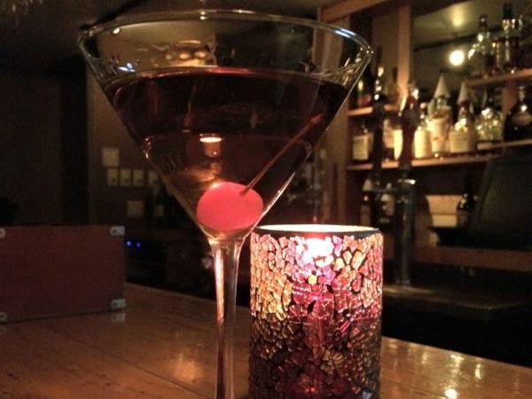 Mareks restaurant Marco Island Manhattan in martini glass on table in front of bar